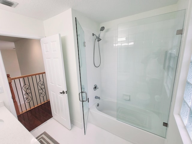 bathroom with a textured ceiling, vanity, and hardwood / wood-style floors