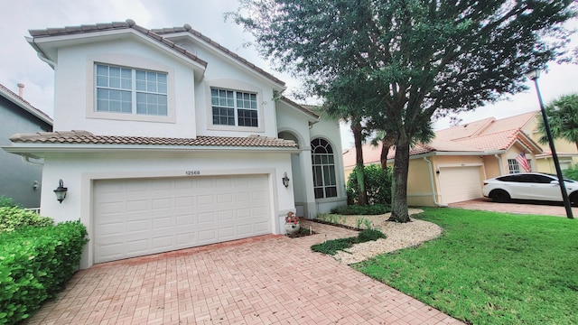 mediterranean / spanish-style home featuring a front lawn