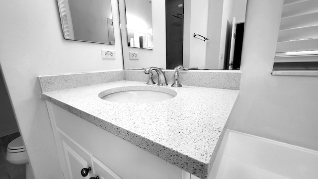 bathroom with vanity and toilet