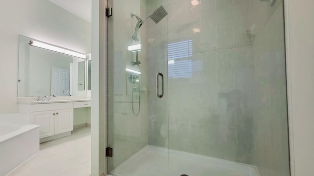 bathroom featuring shower with separate bathtub, vanity, and tile patterned floors