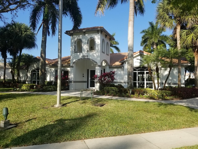 mediterranean / spanish-style house featuring a front yard