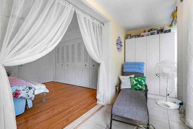 bedroom with light hardwood / wood-style flooring and a closet