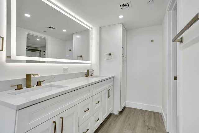 bathroom with vanity and hardwood / wood-style floors