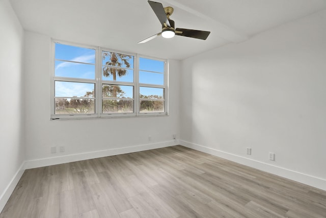 spare room featuring light wood-type flooring and ceiling fan