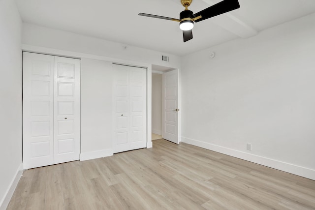 unfurnished bedroom with ceiling fan, light hardwood / wood-style floors, and a closet