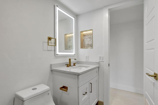 bathroom featuring toilet and vanity