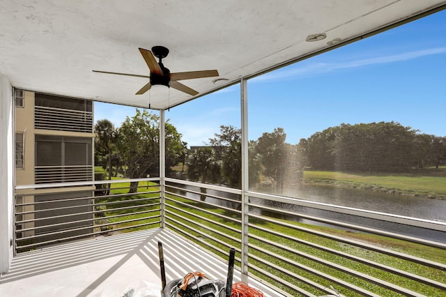 unfurnished sunroom featuring ceiling fan