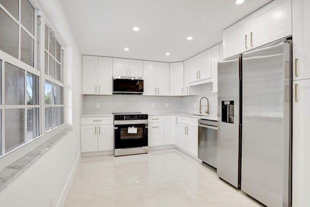 kitchen featuring white cabinetry, sink, and stainless steel appliances