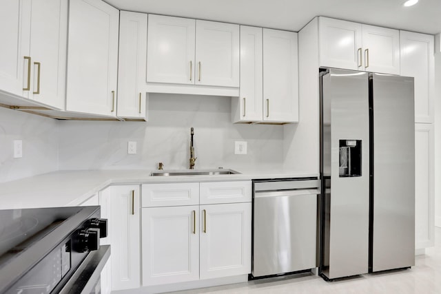 kitchen featuring white cabinetry, stainless steel appliances, and sink