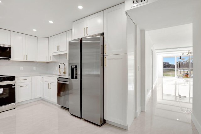 kitchen with white cabinetry, sink, tasteful backsplash, and stainless steel appliances