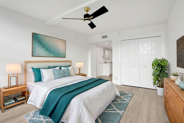 bedroom with light wood-type flooring, a closet, and ceiling fan