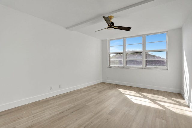 empty room with ceiling fan, beamed ceiling, and light hardwood / wood-style floors