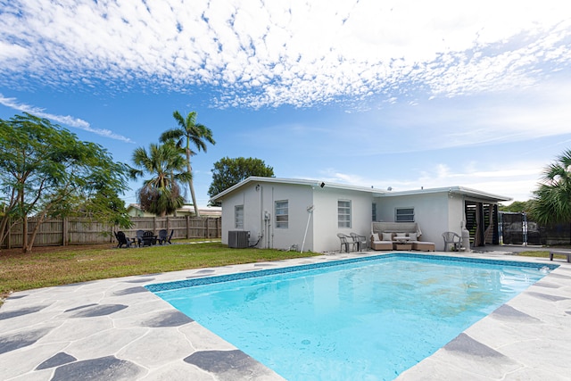 view of swimming pool featuring central AC, a yard, and a patio area