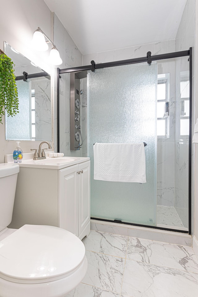 bathroom featuring an enclosed shower, toilet, and vanity