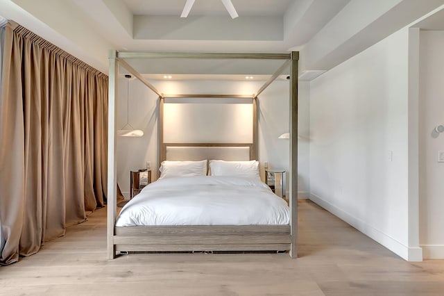 bedroom with ceiling fan and light wood-type flooring