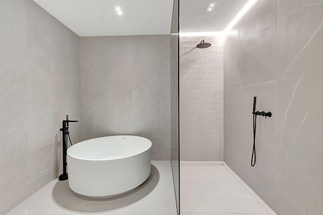 bathroom with separate shower and tub