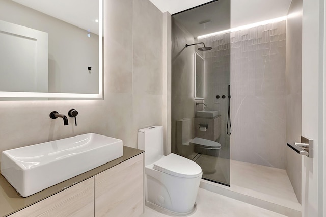 bathroom with tile walls, toilet, a tile shower, and vanity