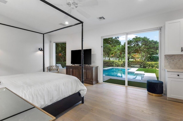 bedroom with light hardwood / wood-style flooring, ceiling fan, and access to outside