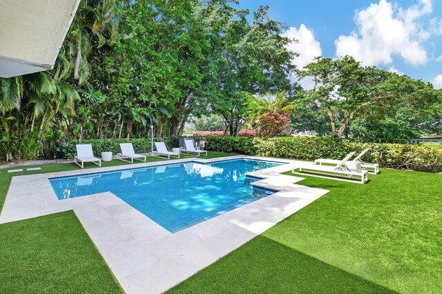 view of pool featuring a yard and a patio