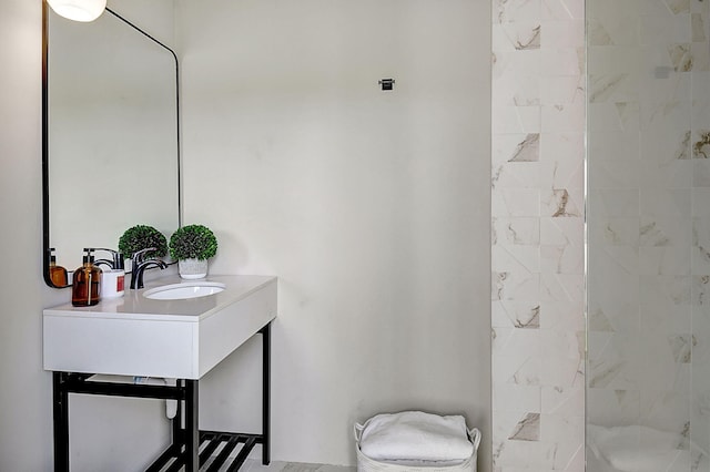 bathroom featuring tiled shower, toilet, and vanity