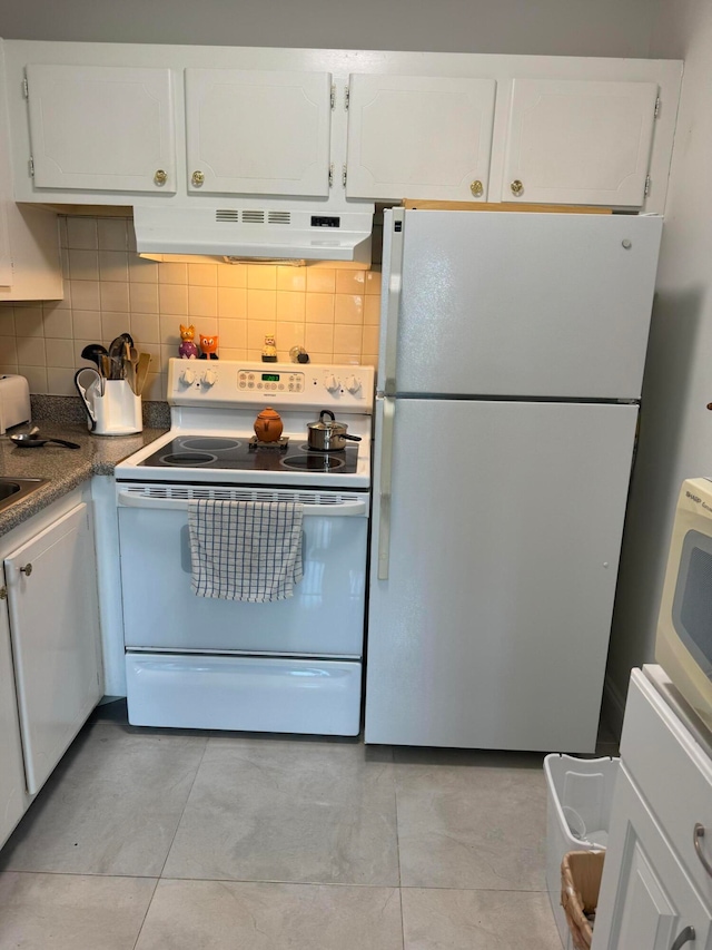 kitchen featuring decorative backsplash, white appliances, white cabinetry, and light tile patterned floors