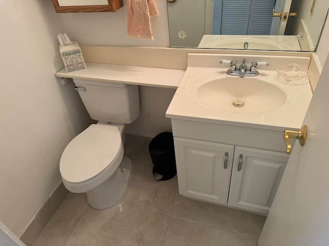 bathroom with tile patterned floors, vanity, and toilet