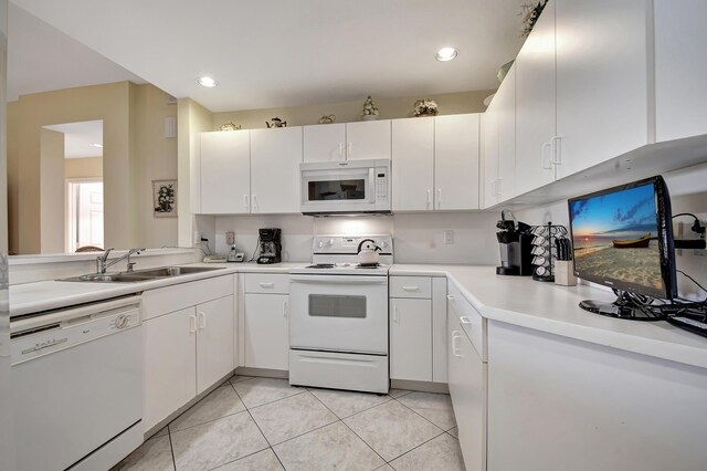 kitchen featuring white cabinets, white appliances, light tile patterned flooring, and sink