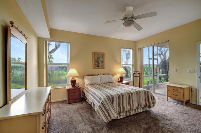 bedroom with multiple windows, access to outside, and ceiling fan