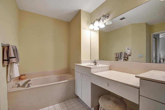 bathroom with vanity, a bathing tub, and tile patterned floors