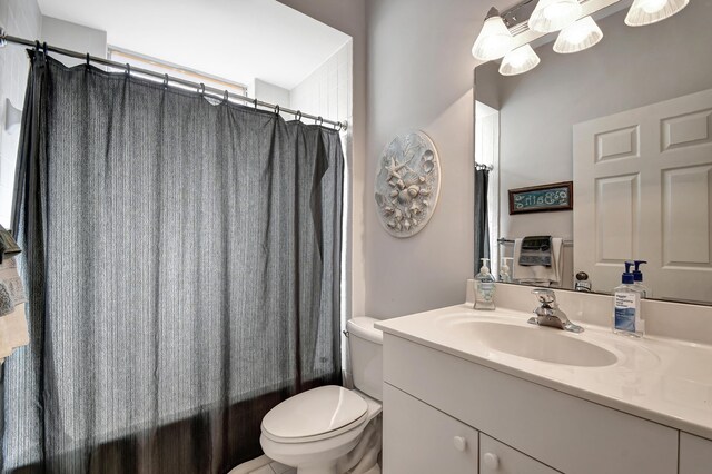 full bathroom with vanity, toilet, and shower / bath combo with shower curtain