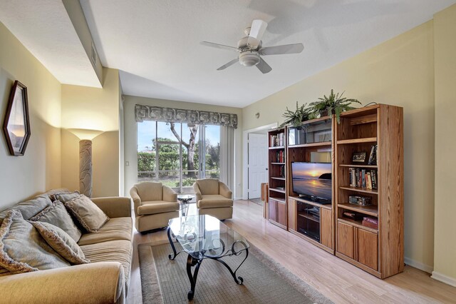 living room featuring light wood-type flooring and ceiling fan