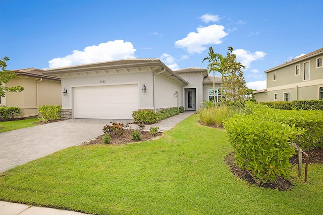 view of front of property featuring a garage and a front yard