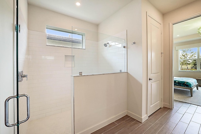 bathroom featuring a shower with door