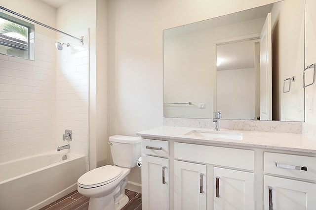 full bathroom with tiled shower / bath combo, vanity, and toilet