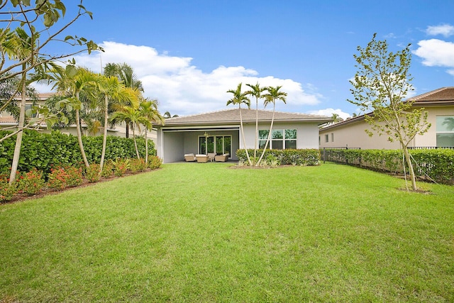 back of property with a yard and an outdoor hangout area