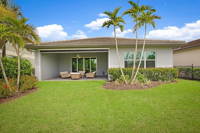 back of house with a patio area, a yard, and an outdoor living space