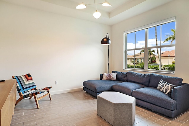 living room featuring a raised ceiling