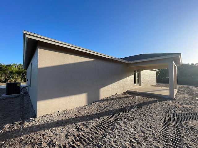 view of property exterior with a patio and central air condition unit