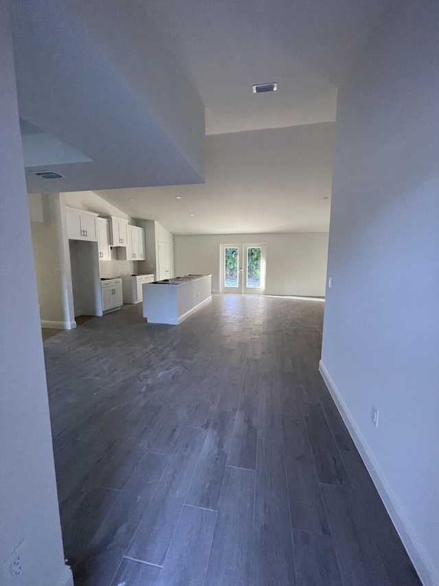 unfurnished living room with french doors and dark hardwood / wood-style floors