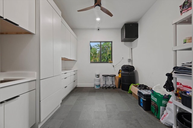 interior space with ceiling fan