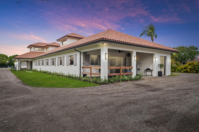 property exterior at dusk with ceiling fan