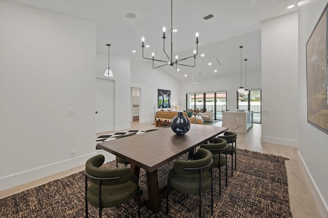 dining room with high vaulted ceiling and an inviting chandelier