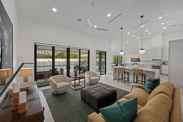 living room featuring light wood-type flooring, french doors, and ceiling fan