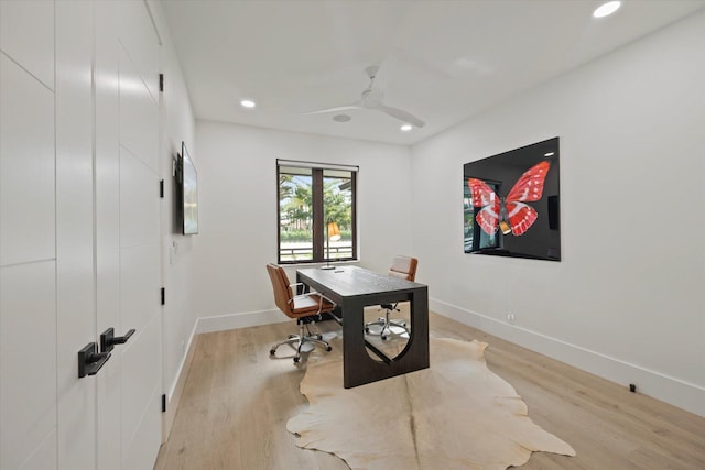 office space featuring ceiling fan and light hardwood / wood-style floors