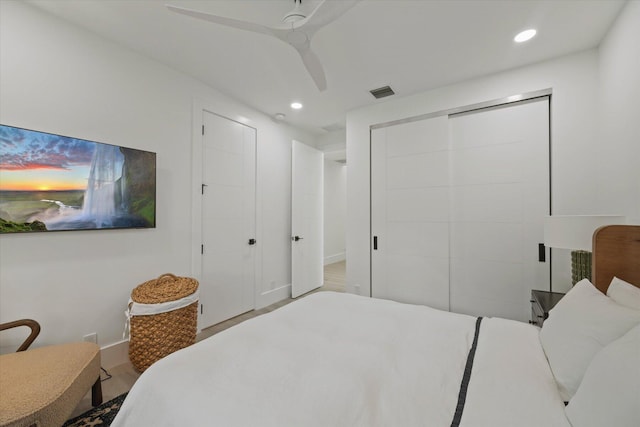 bedroom with a closet, ceiling fan, and light hardwood / wood-style floors