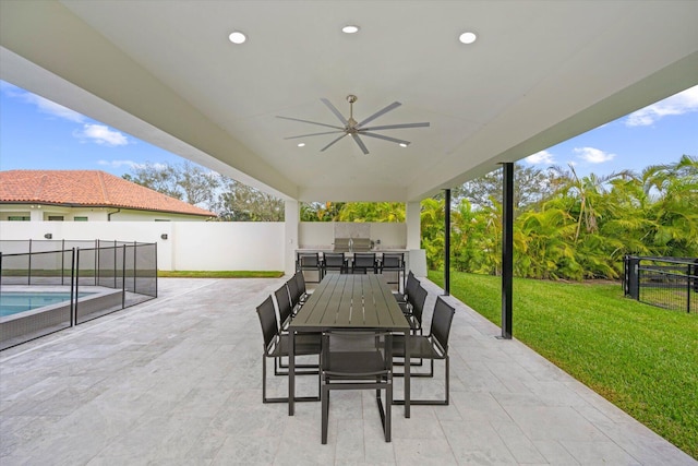 view of patio / terrace with a fenced in pool and ceiling fan