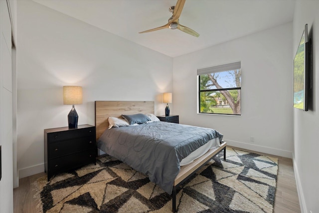 bedroom featuring vaulted ceiling, hardwood / wood-style flooring, and ceiling fan