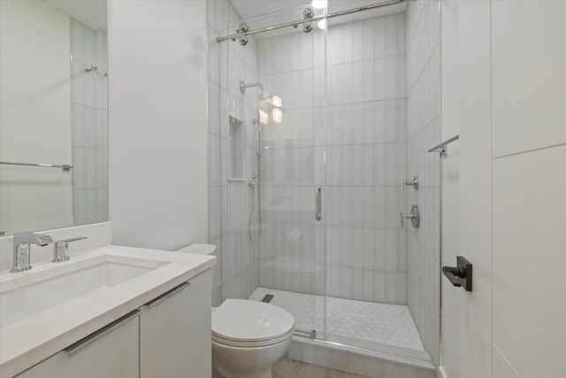 bathroom with vanity, toilet, and walk in shower