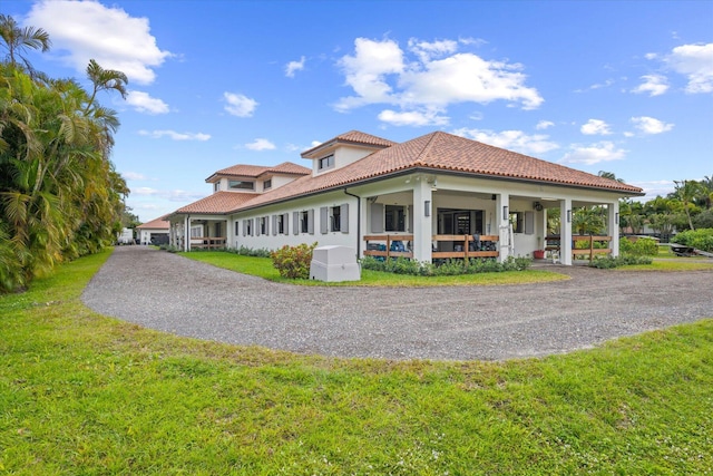 mediterranean / spanish house with a front lawn