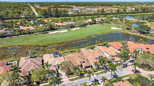 aerial view featuring a residential view, golf course view, and a water view